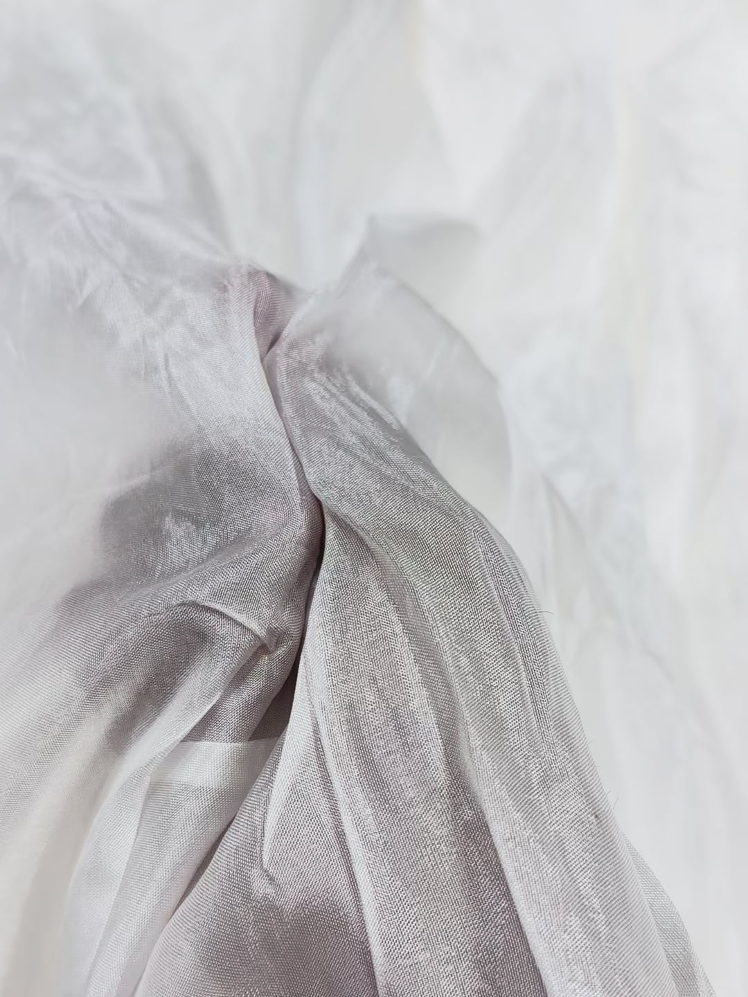 Close-up of white uppada silk fabric with subtle texture